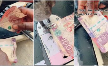 Nigerian man seen sewing together the one hundred naira note
