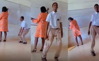 Bold student dances in front of class as teacher writes on the board | Ikejabird.com