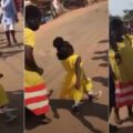 Small school girl astounds viewers with zeal while marching with schoolmates