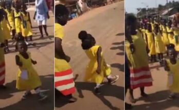 Small school girl astounds viewers with zeal while marching with schoolmates