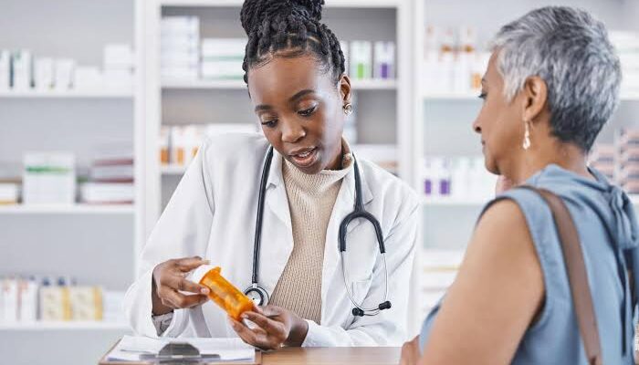 A pharmacist speaking to her patients