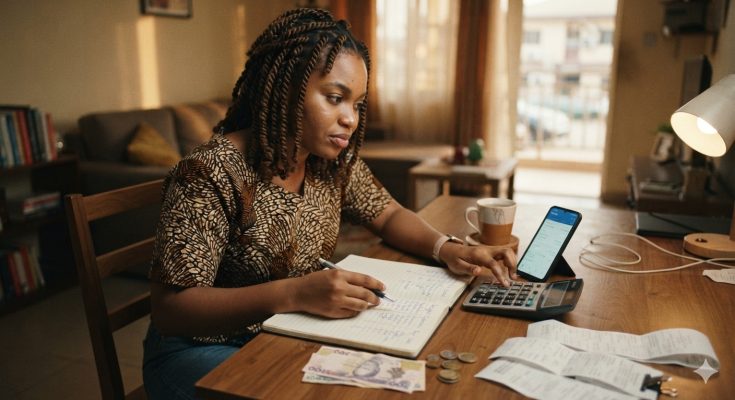 Young Nigerian adult reviewing a monthly budget